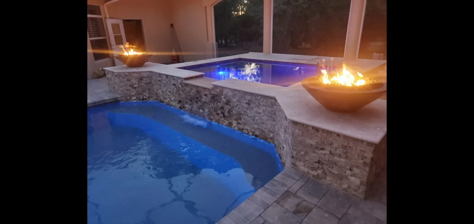 Deck jets and water features installed around residential swimming pool