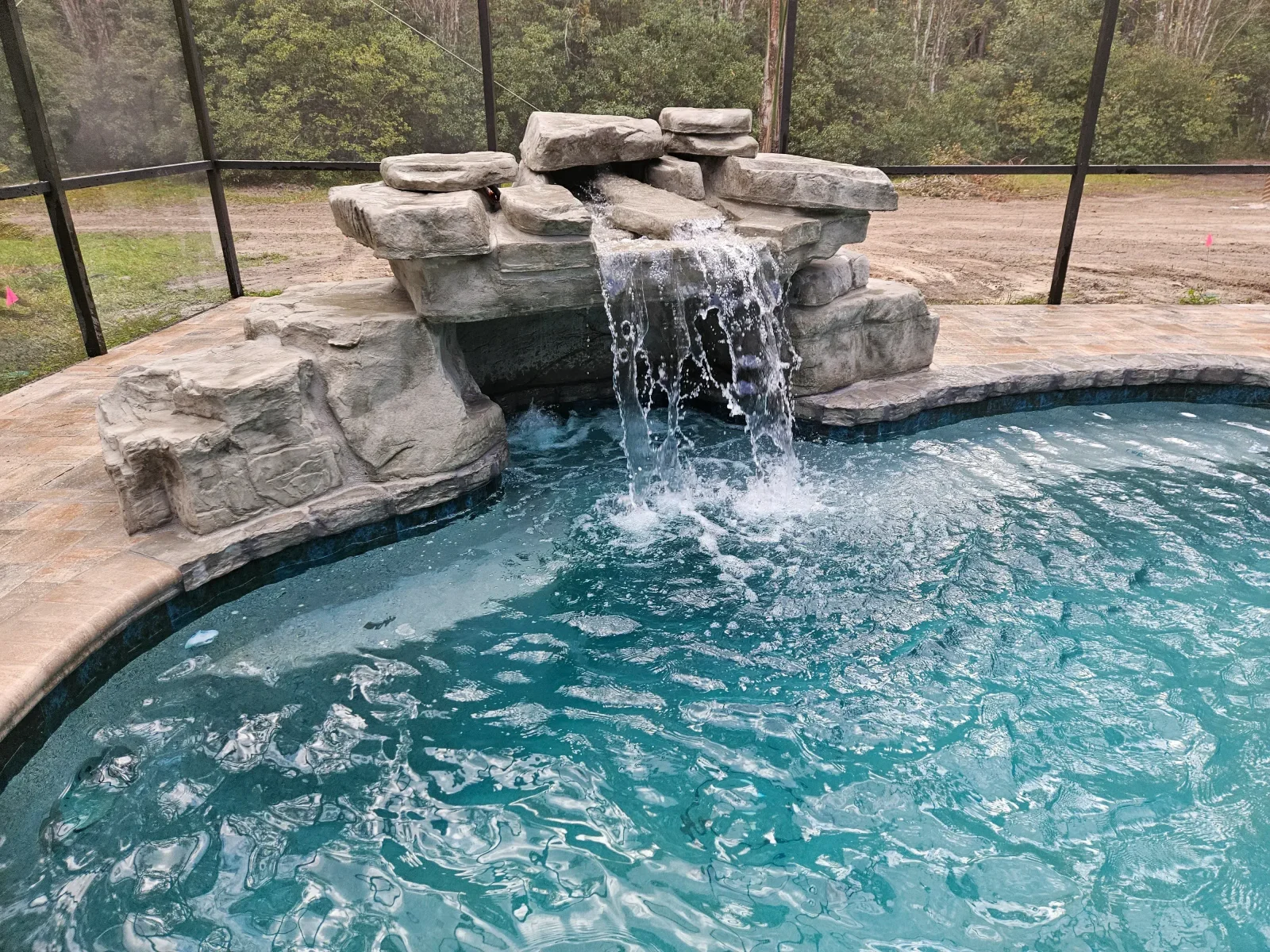 Pool contractor installing new waterline tile on residential swimming pool in Pasco County